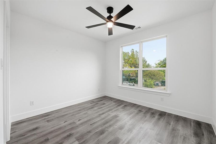 Unfurnished room featuring light wood-style flooring and a ceiling fan