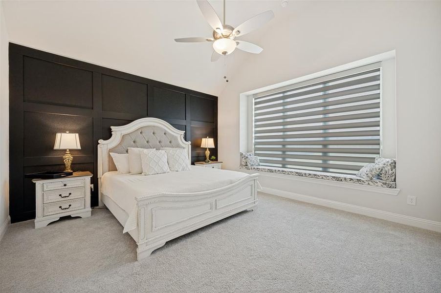 Unwind in this spacious and inviting primary bedroom featuring a designer accent wall, oversized picture window with abundant natural light, and plenty of room for a king-sized bed and additional furnishings. The neutral color palette and plush carpeting create a warm, relaxing atmosphere, while the generous layout provides the perfect private retreat to start and end your day. Unwind in this spacious and inviting primary bedroom featuring a designer accent wall, oversized picture window with abundant natural light, and plenty of room for a king-sized bed and additional furnishings. The neutral color palette and plush carpeting create a warm, relaxing atmosphere, while the generous layout provides the perfect private retreat to start and end your day.