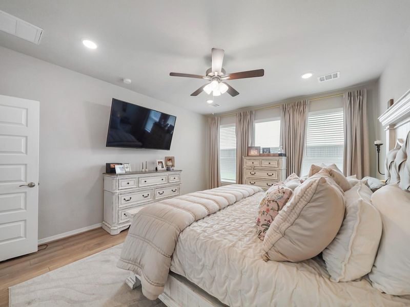 Well-proportioned and filled with natural light, the primary bedroom provides flexibility for both comfort and style.