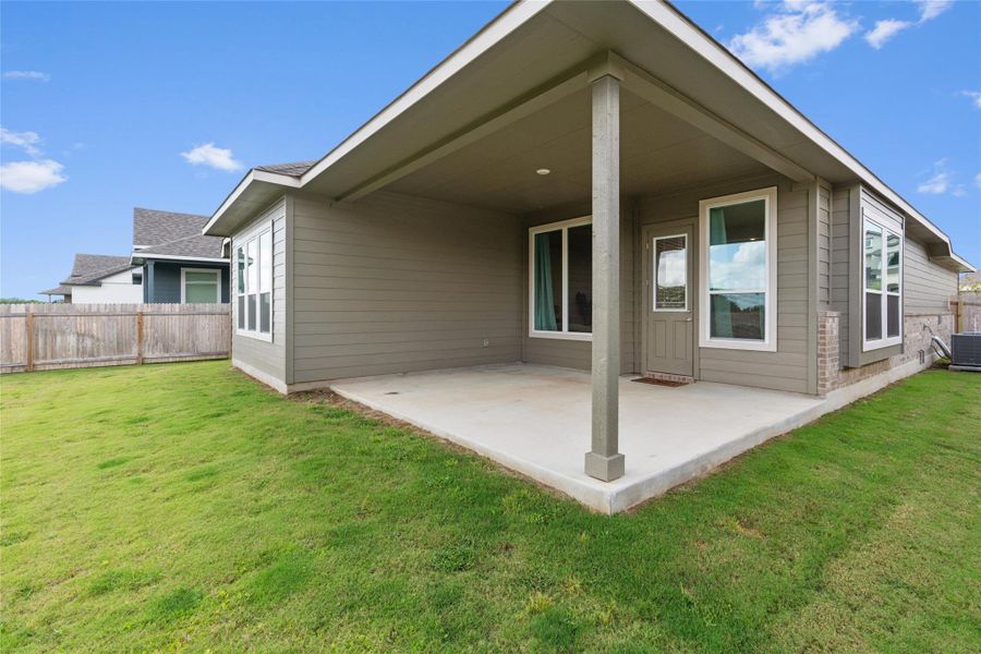 A spacious covered patio provides an ideal setting for outdoor entertaining and enjoying the private yard.