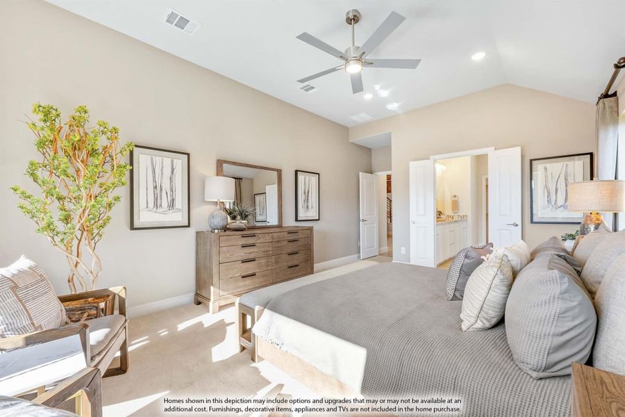 Master bedroom with vaulted ceiling, ceiling fan, wood dresser, and open ensuite bathroom door Master bedroom with vaulted ceiling, ceiling fan, wood dresser, and open ensuite bathroom door