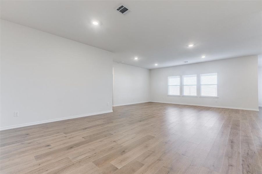 Empty room with light hardwood / wood-style floors