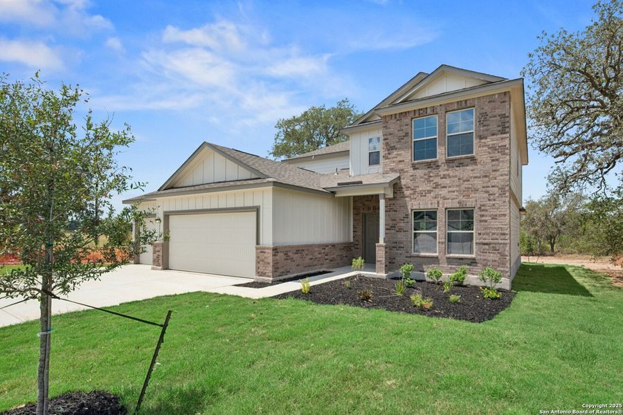 Front exterior of a new home in Jordan's Ranch, San Antonio, TX, highlighting curb appeal (Image 13). Front exterior of a new home in Jordan's Ranch, San Antonio, TX, highlighting curb appeal (Image 13).