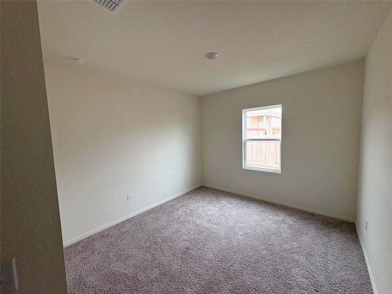 Carpeted empty room featuring baseboards Carpeted empty room featuring baseboards