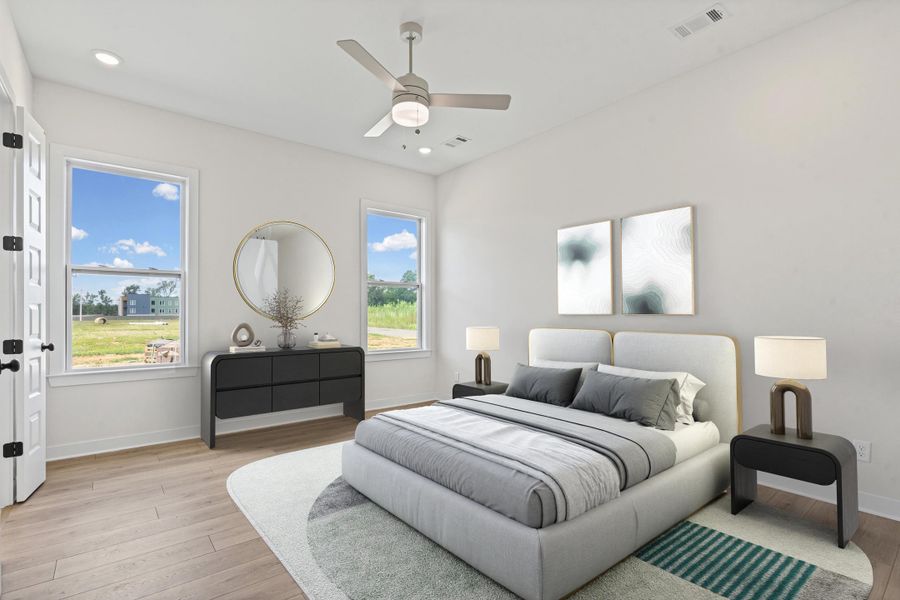 Bright bedroom with wood-finish flooring and white walls Bright bedroom with wood-finish flooring and white walls