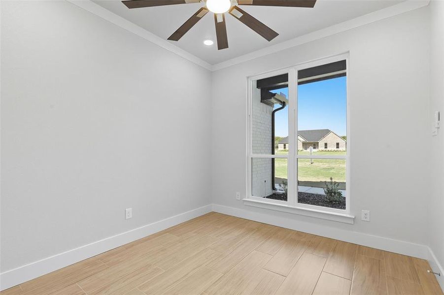 Unfurnished room with ornamental molding, wood tiled floors, recessed lighting, and a ceiling fan Unfurnished room with ornamental molding, wood tiled floors, recessed lighting, and a ceiling fan