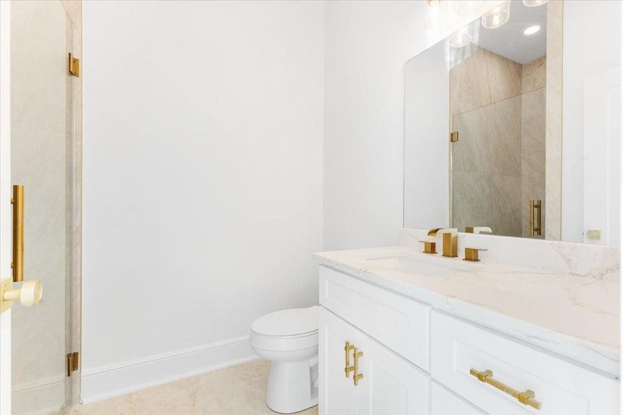 Secondary bathroom featuring a spacious vanity with ample counter space and storage. Secondary bathroom featuring a spacious vanity with ample counter space and storage.