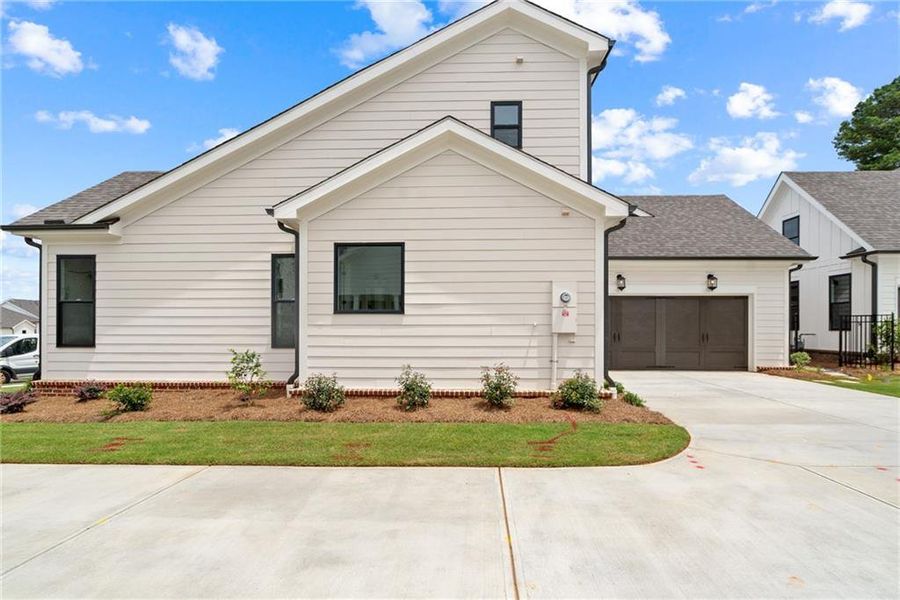 Front exterior of a new home in Promenade at Sawnee Village, Cumming, GA, highlighting curb appeal (Image 20).