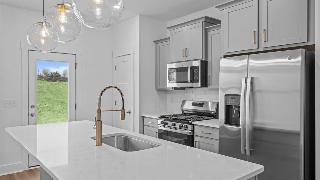 Modern kitchen with streamlined island for easy prep, storage, and gathering at this townhome community in Anderson, SC