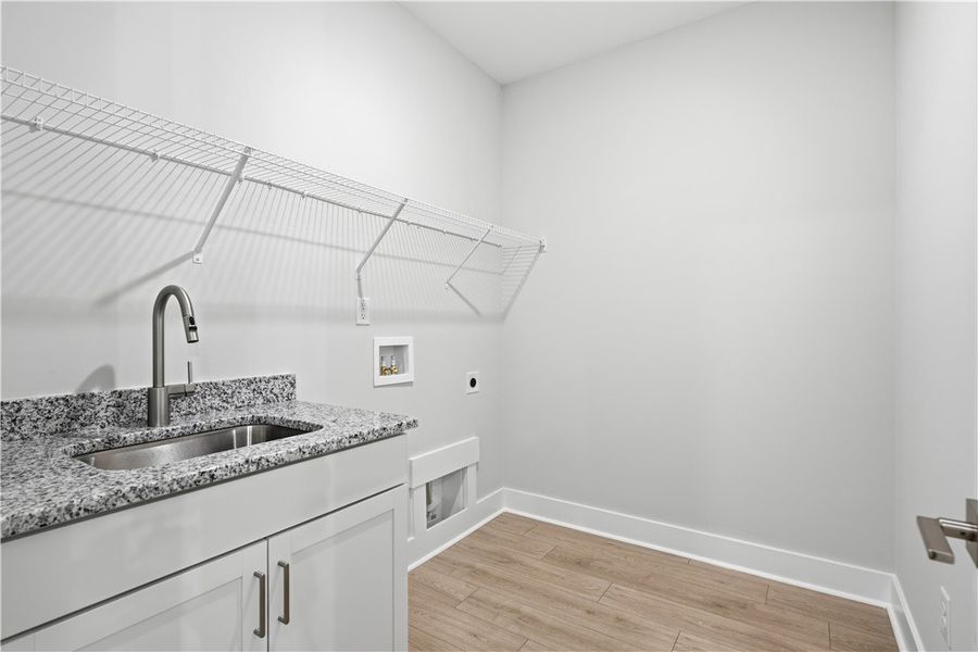 An organized laundry room features durable stone c