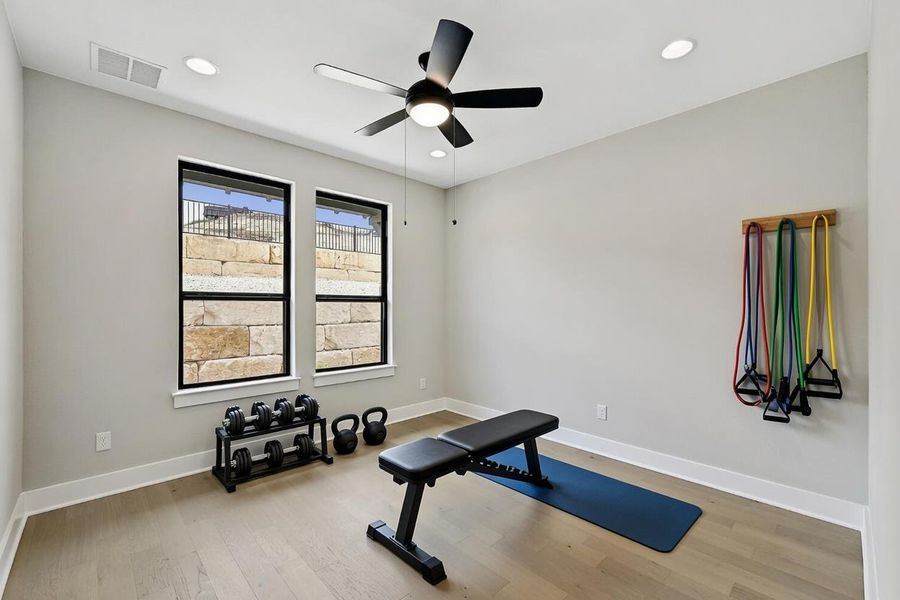 (Virtual) Well-lit room provides a flexible space for recreation, complemented by light hardwood flooring and recessed ceiling lighting. (Virtual) Well-lit room provides a flexible space for recreation, complemented by light hardwood flooring and recessed ceiling lighting.