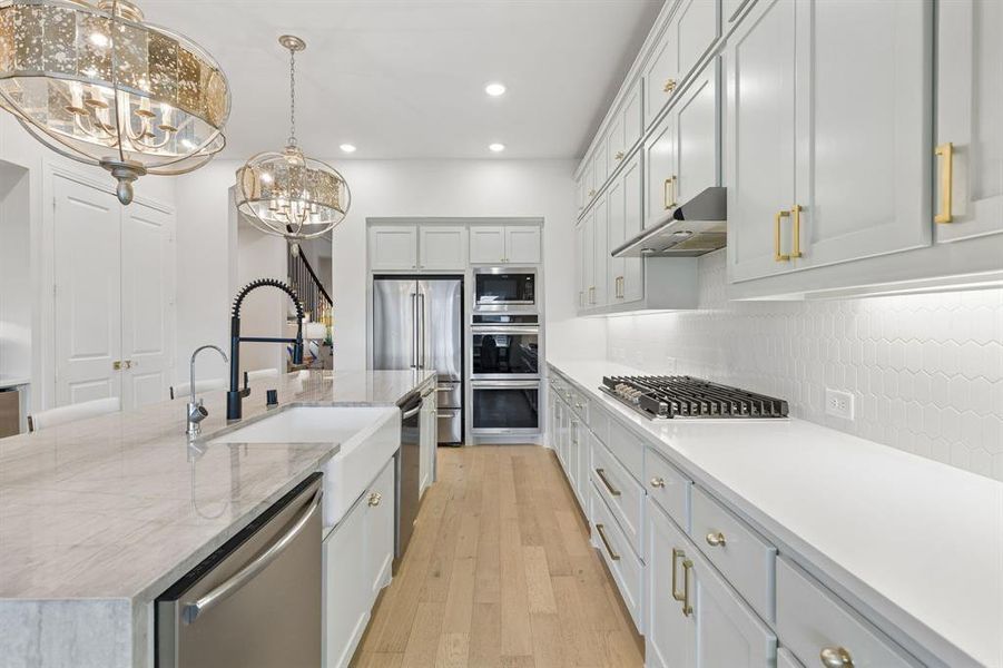 Two dishwashers in kitchen and double ovens