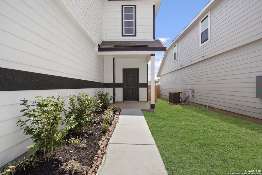 Front exterior of a new home in Abbott Place, St. Hedwig, TX, highlighting curb appeal (Image 1).