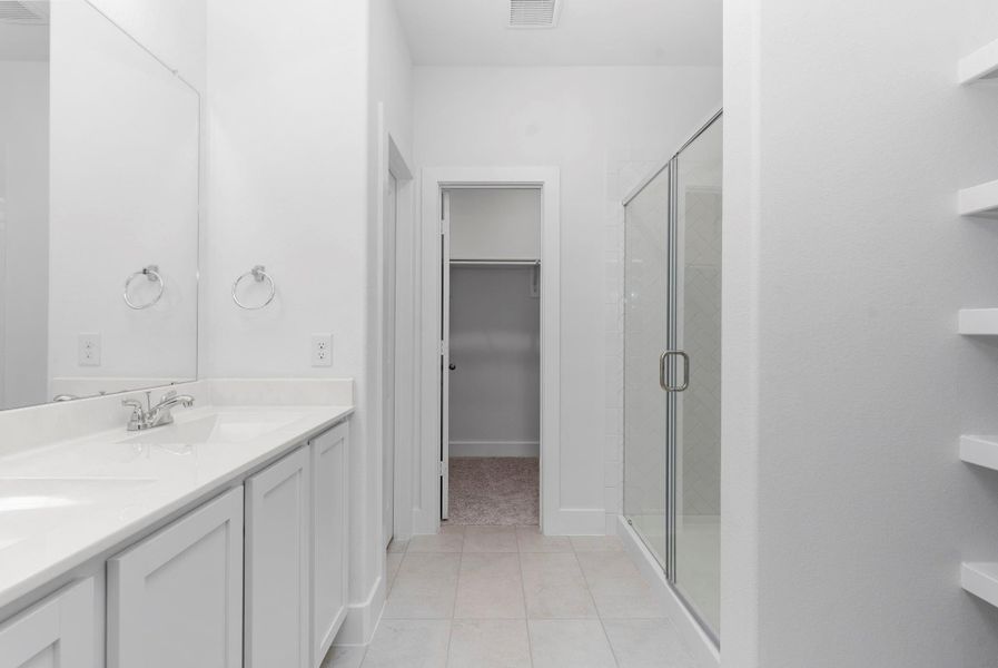 The spa-like primary bathroom was thoughtfully designed with dual vanities, beautiful white shaker cabinetry, and ample lighting. It’s a luxurious space built for comfort, convenience, and daily pampering. The spa-like primary bathroom was thoughtfully designed with dual vanities, beautiful white shaker cabinetry, and ample lighting. It’s a luxurious space built for comfort, convenience, and daily pampering.