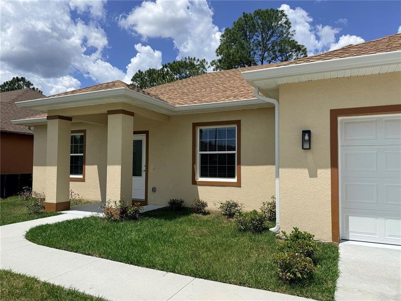Front exterior of a new home in , Palm Coast, FL, highlighting curb appeal (Image 26).