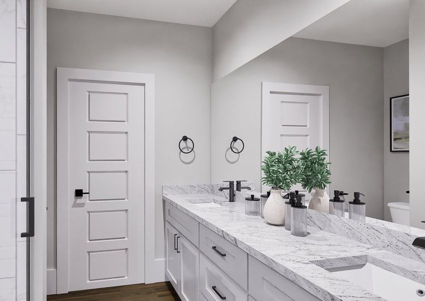 A modern bathroom with a granite countertop, black fixtures, and double sinks. A plant and toiletries are on the counter. The shower has a glass door.