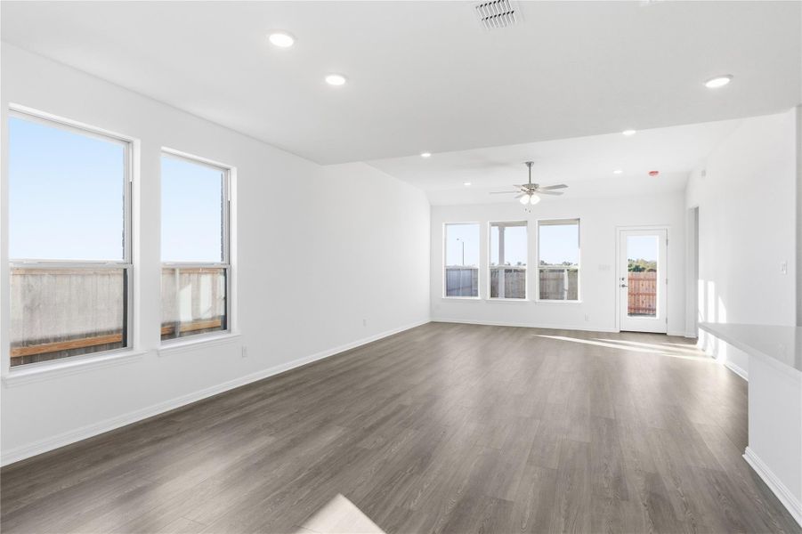 Unfurnished living room with recessed lighting, dark wood finished floors, and ceiling fan