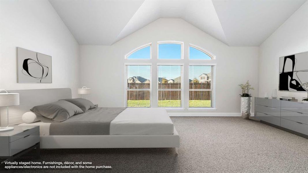 Carpeted bedroom featuring lofted ceiling