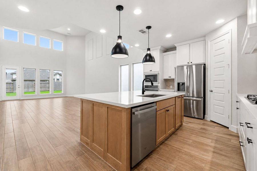 The thoughtfully designed open-concept floor plan seamlessly connects the kitchen, dining area, and family room, creating the perfect space for everyday living and entertaining.