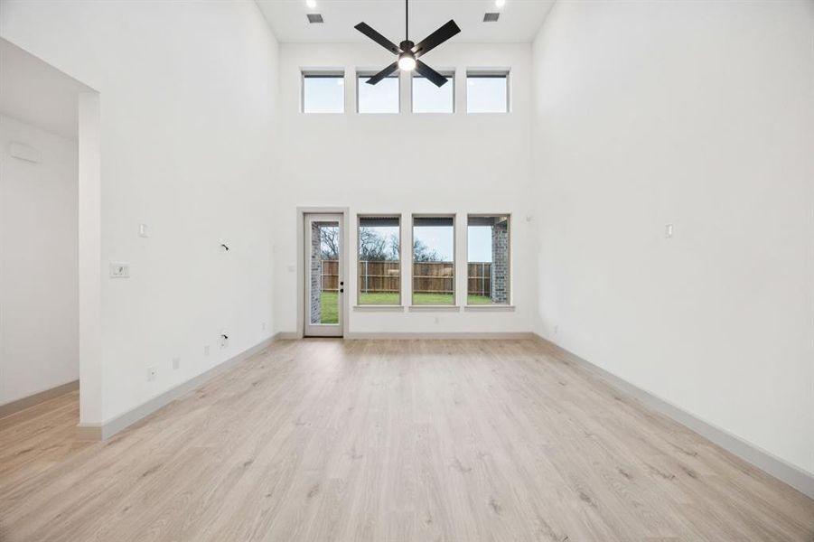 Your new family room is flooded with natural light from a wall of double stacked windows!