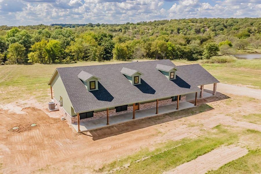 Aerial view of property and surrounding area with a forest Aerial view of property and surrounding area with a forest