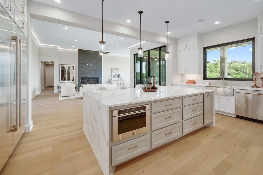 An open-concept living space connects a gourmet kitchen and inviting living room, perfect for entertaining.