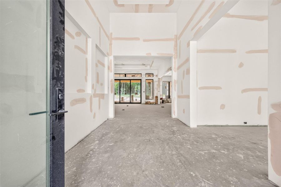 Welcoming entry leading to the family room with formal dining to the right.