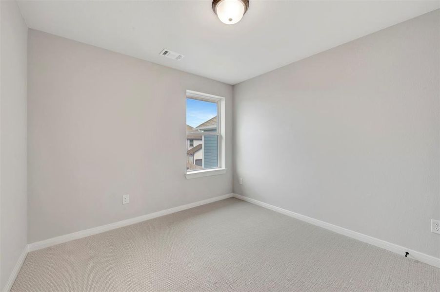 Spare room featuring baseboards and carpet flooring