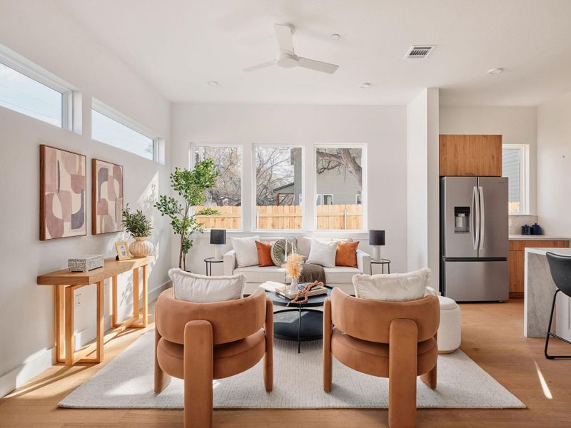 Living area featuring light wood-type flooring and a ceiling fan
