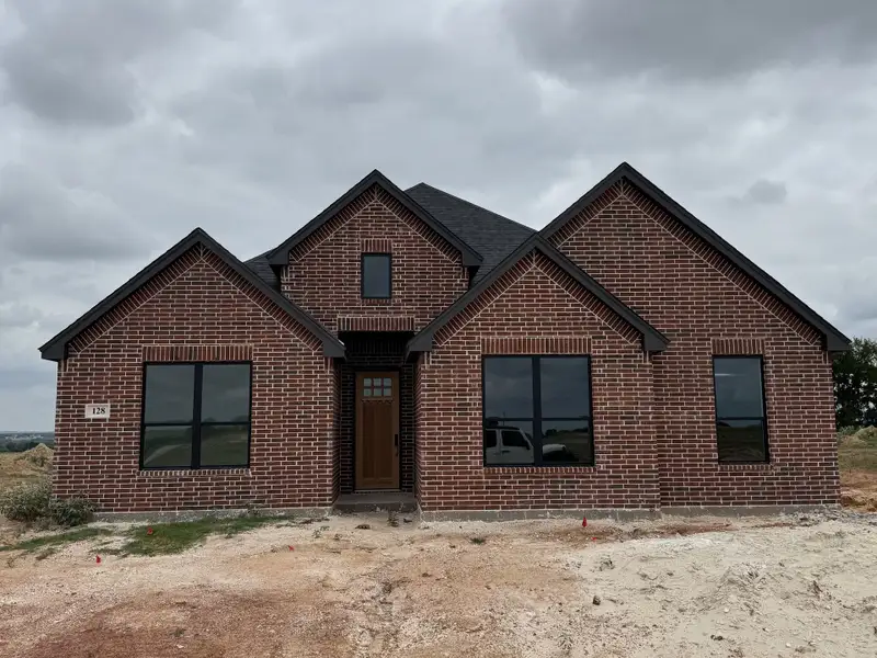 Front exterior of a new home in Stagecoach Crossing, Bridgeport, TX, highlighting curb appeal (Image 1). Front exterior of a new home in Stagecoach Crossing, Bridgeport, TX, highlighting curb appeal (Image 1).