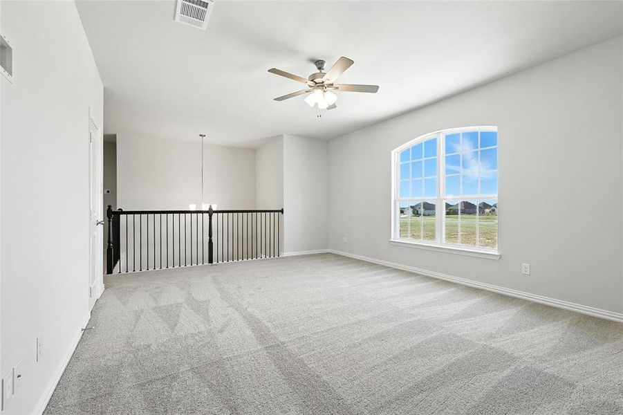 Empty room with carpet floors and ceiling fan Empty room with carpet floors and ceiling fan