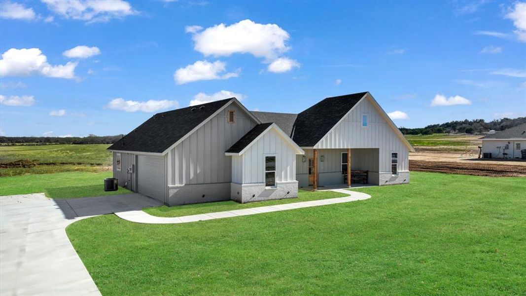 Front exterior of a new home in Parallel Pastures, Poolville, TX, highlighting curb appeal (Image 25).