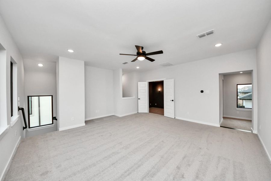 To the right are steps down to a large room over looking the main stairs. The media room is straight a head and the stairway to the left takes us down to the kitchen.