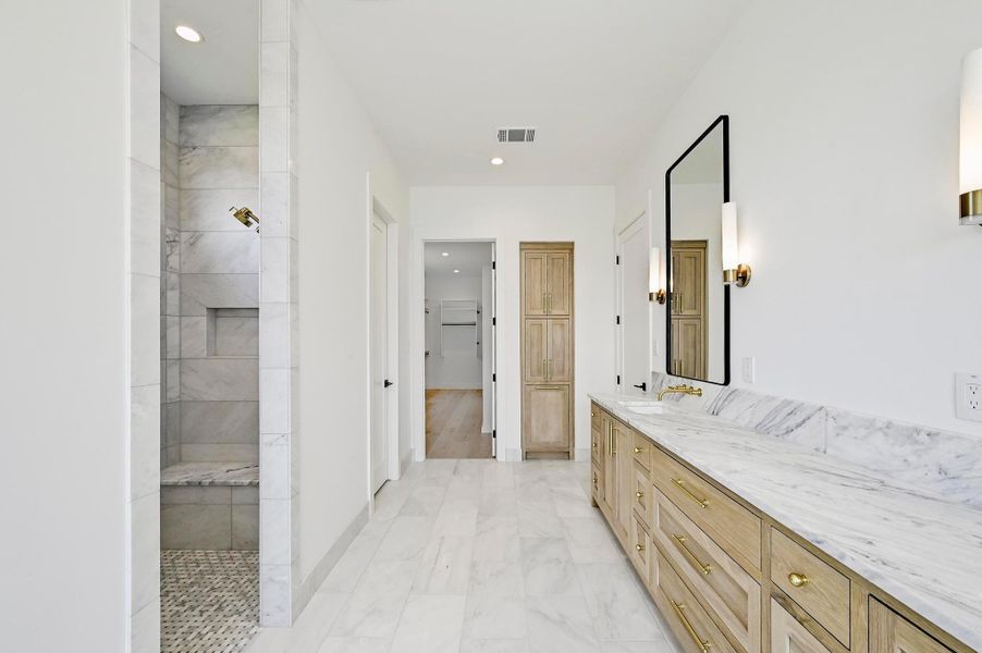 Walk-in shower has dual heads with separate rain shower head. Walk-in shower has dual heads with separate rain shower head.