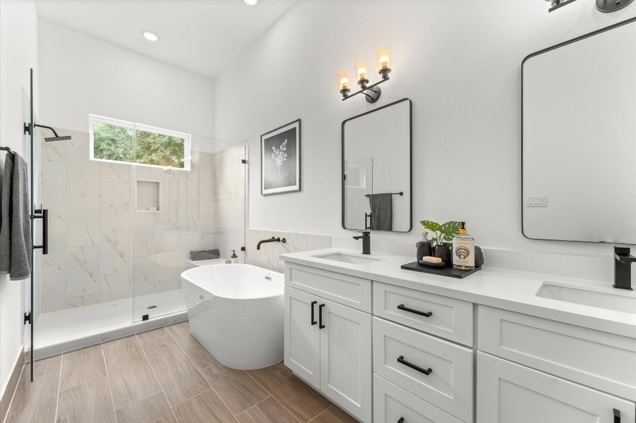 Elegant and serene primary bathroom designed to offer both style and functionality. The space features a luxurious soaking tub ideal for unwinding, a separate glass-enclosed shower for quick refreshes, and a sleek double vanity with ample countertop space and storage—perfect for busy mornings or relaxing evenings. Elegant and serene primary bathroom designed to offer both style and functionality. The space features a luxurious soaking tub ideal for unwinding, a separate glass-enclosed shower for quick refreshes, and a sleek double vanity with ample countertop space and storage—perfect for busy mornings or relaxing evenings.