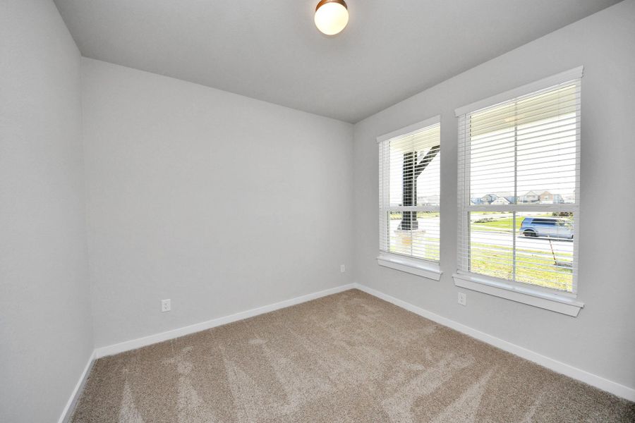 At the forefront, a refined home office beckons productivity and focus. Luxurious details like plush carpeting, custom paint, expansive windows with privacy blinds, and French doors create an inspiring workspace. Sample photo of completed home with similar floor plan. Actual colors and selections may vary. At the forefront, a refined home office beckons productivity and focus. Luxurious details like plush carpeting, custom paint, expansive windows with privacy blinds, and French doors create an inspiring workspace. Sample photo of completed home with similar floor plan. Actual colors and selections may vary.