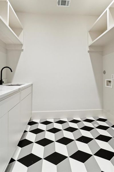 The addition of the geometric tile to the laundry room greatly enhances the overall aesthetic appeal of the space.