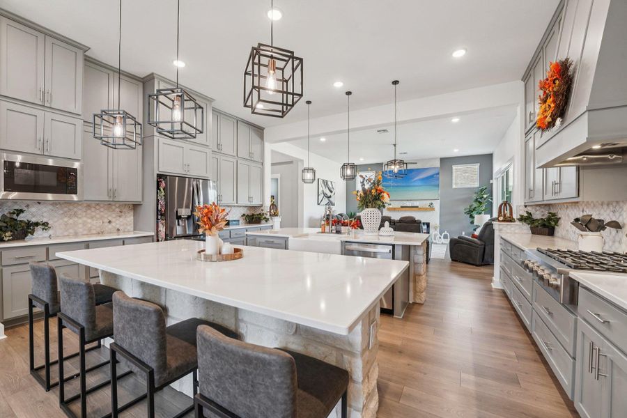 An open view to the living and dining areas keeps the cook connected to the flow of the home.