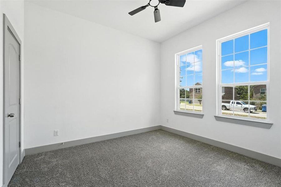 Unfurnished room with carpet flooring and ceiling fan Unfurnished room with carpet flooring and ceiling fan