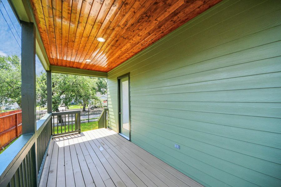 Enjoy seamless indoor-outdoor living on this spacious covered patio featuring a beautiful cedar ceiling, recessed lighting, and plenty of room for outdoor dining entertaining, or relaxing while overlooking the private fenced yard.
