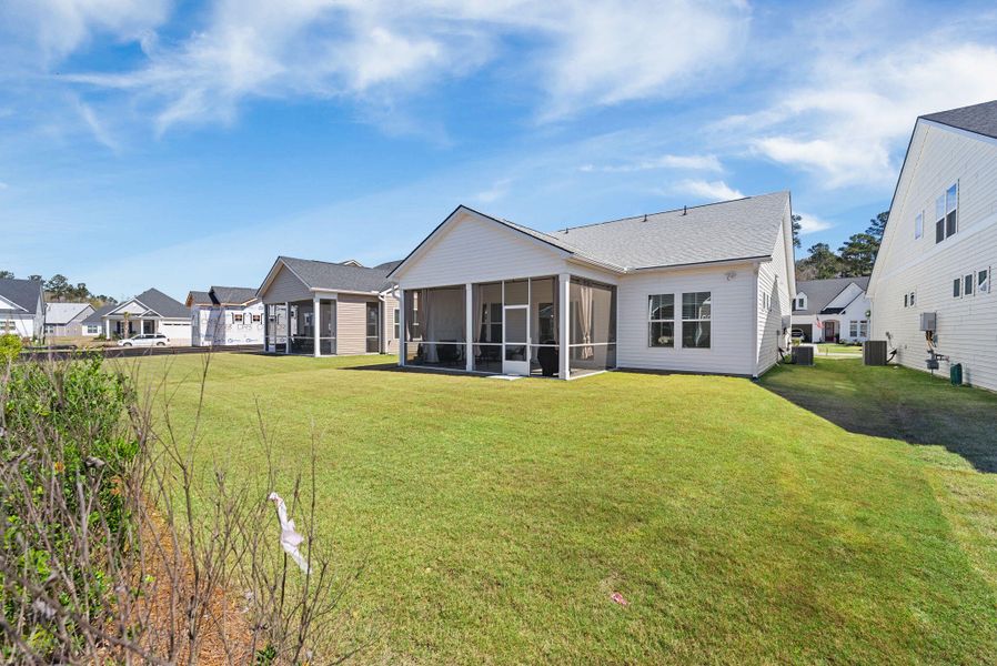 Exterior details and patio area of a home in Summerwind Crossing at Lakes of Cane Bay, Summerville (Image 29).