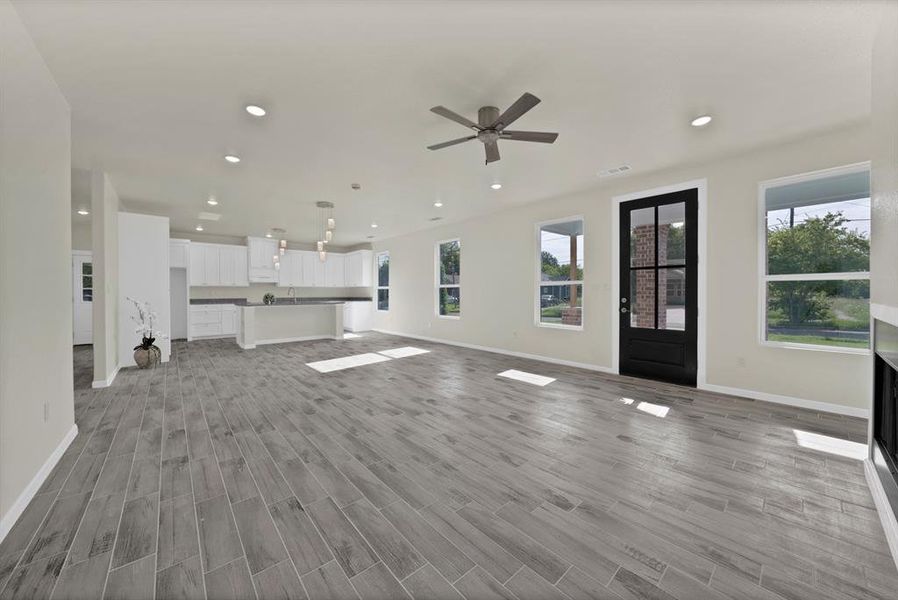 Unfurnished living room featuring light wood-style flooring, recessed lighting, and ceiling fan