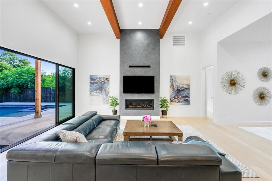 Living room featuring a fireplace, light wood-style flooring, and recessed lighting