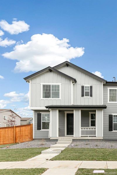 Front exterior of a new home in Sky Ranch Villas, Watkins, CO, highlighting curb appeal (Image 1).