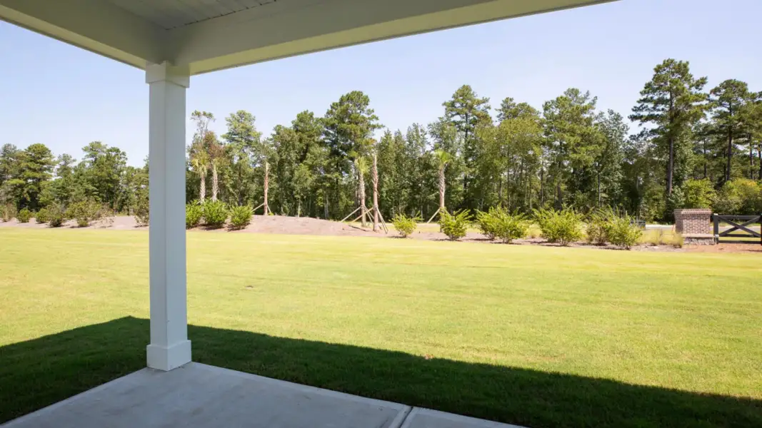 Exterior details and patio area of a home in The Retreat at Indigo Preserve Townhomes, Leland (Image 3).