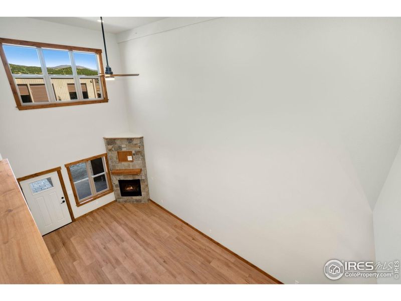 View looking down to the main level living area from the loft
