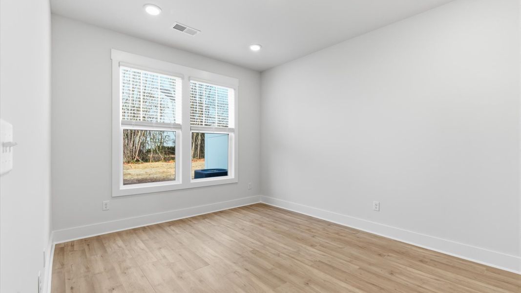 First-class hardwood floors and tasteful finishes elevate the private retreat of this exceptional primary suite