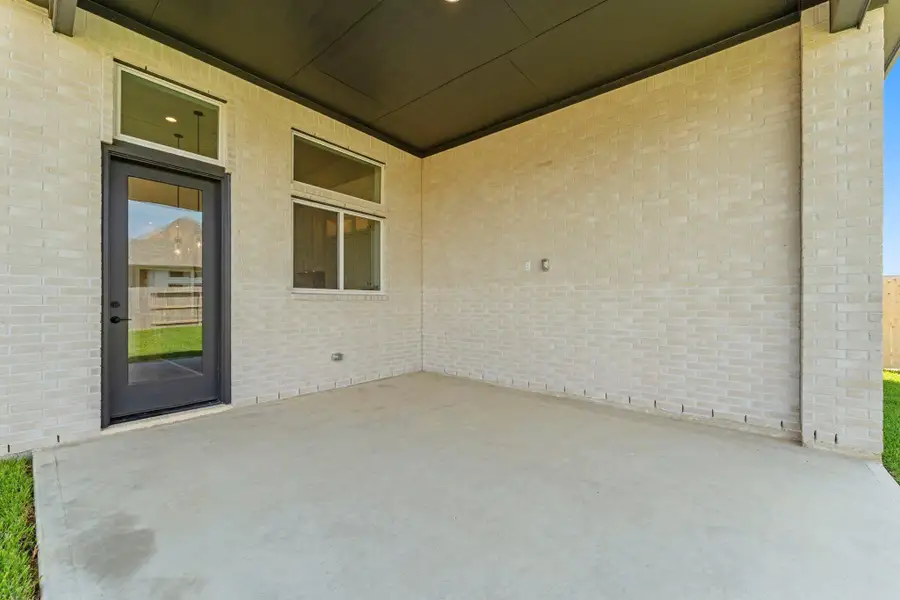 Covered Rear Patio with Access to Great Room and Fenced Back Yard