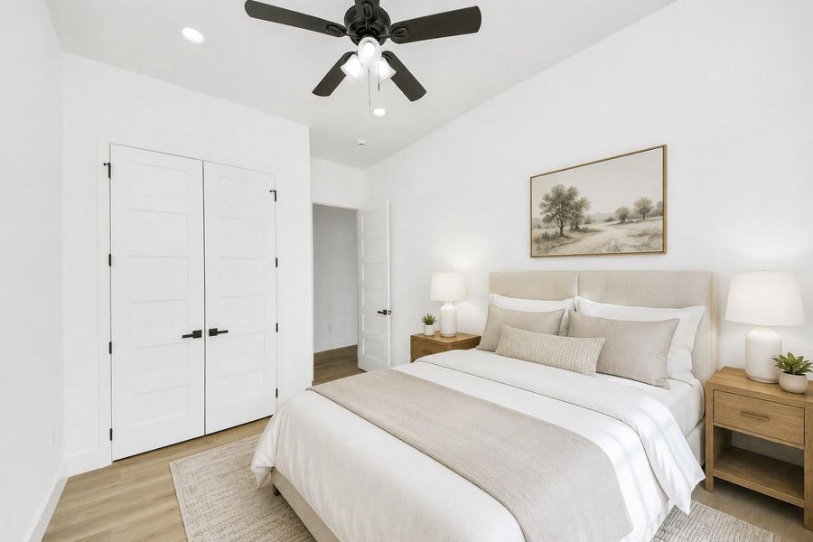 Bright guest bedroom with abundant natural light and a clean, modern feel.