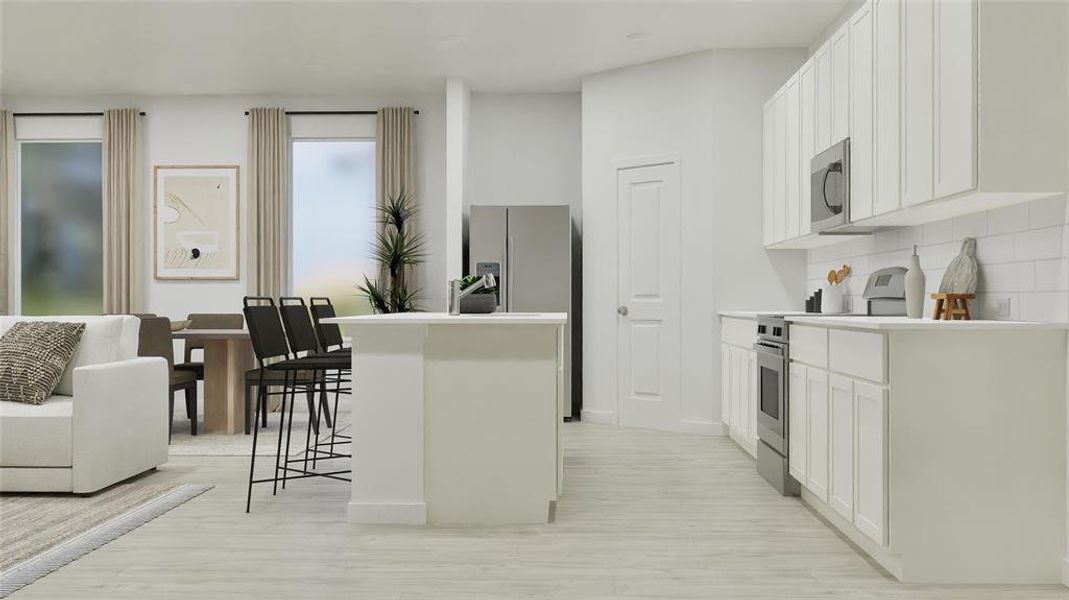 Kitchen featuring appliances with stainless steel finishes, a center island, light countertops, white cabinetry, and a breakfast bar area Kitchen featuring appliances with stainless steel finishes, a center island, light countertops, white cabinetry, and a breakfast bar area